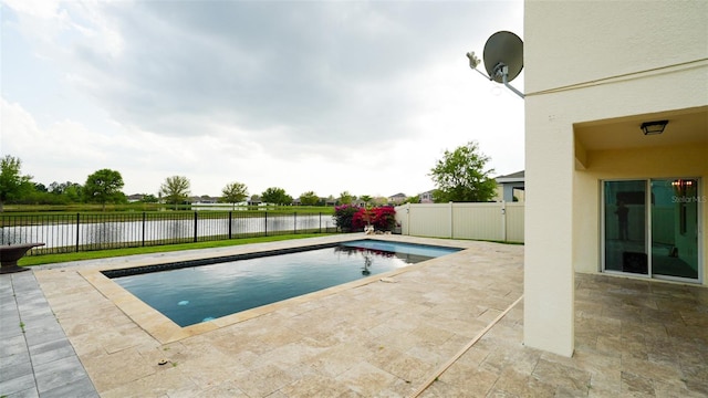 view of pool with a patio, a fenced backyard, a fenced in pool, and a water view