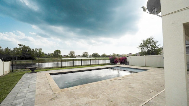 view of swimming pool with a water view, a patio area, a fenced in pool, and a fenced backyard