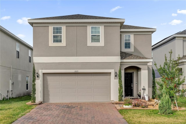 view of front of house featuring a garage and a front lawn