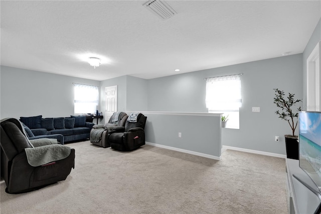 living room with light carpet and a textured ceiling