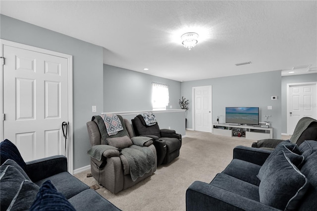 living room featuring light carpet and a textured ceiling