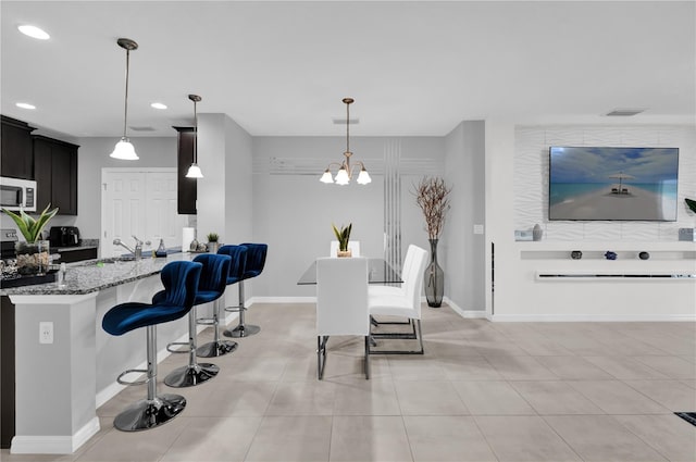 interior space featuring sink, light tile patterned floors, and a notable chandelier