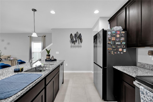 kitchen featuring sink, dishwasher, dark brown cabinets, light stone countertops, and decorative light fixtures