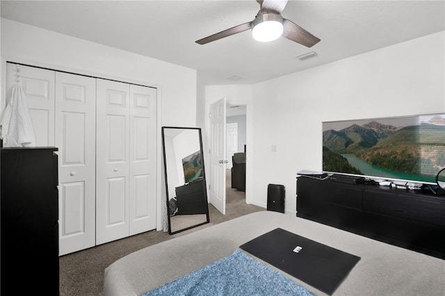 carpeted bedroom featuring ceiling fan and a closet