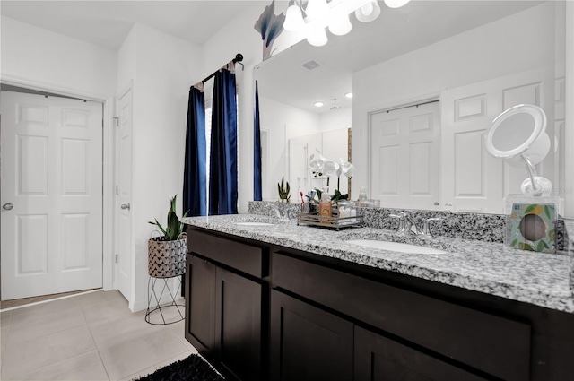 bathroom featuring tile patterned flooring, vanity, and a shower with door