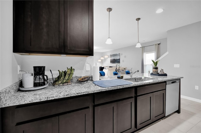 kitchen with decorative light fixtures, dishwasher, sink, dark brown cabinetry, and light stone countertops