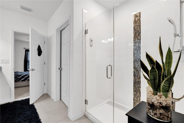 bathroom featuring tile patterned flooring and a shower with shower door