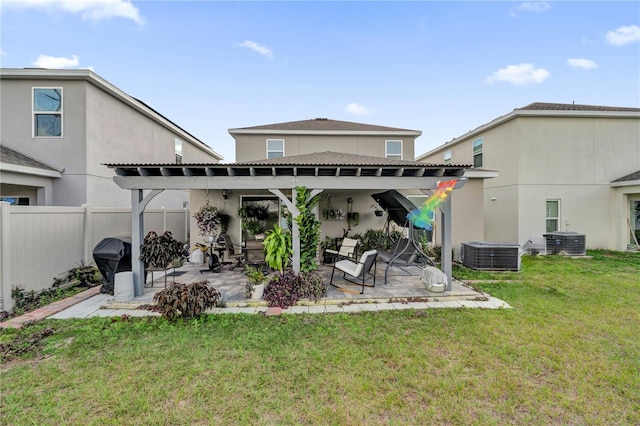 rear view of house featuring a yard, a pergola, central AC, and a patio area