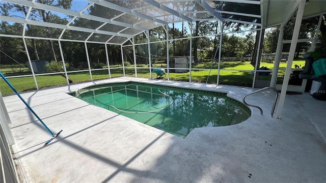 view of pool featuring a storage shed, a yard, a patio, and glass enclosure