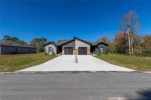 modern home with concrete driveway, an attached garage, and a front lawn