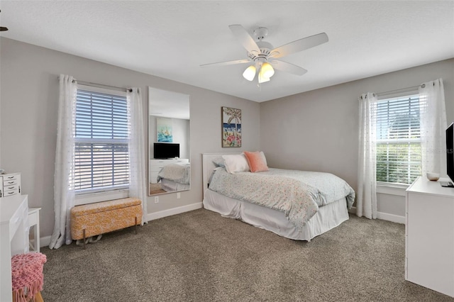 bedroom featuring ceiling fan and carpet