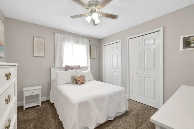 carpeted bedroom with two closets and ceiling fan