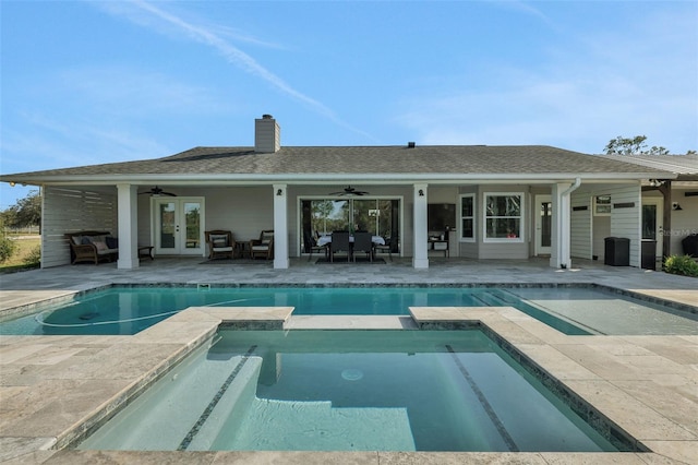 rear view of house with a pool with hot tub, a patio area, ceiling fan, and french doors