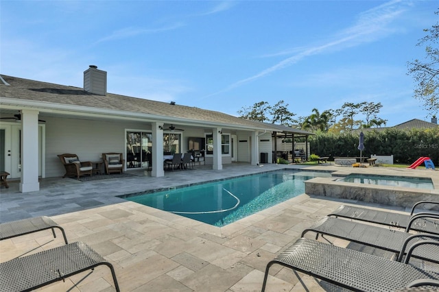 view of swimming pool featuring an in ground hot tub, ceiling fan, and a patio area