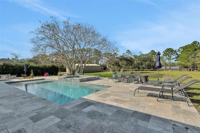 view of swimming pool with an in ground hot tub, a yard, and a patio