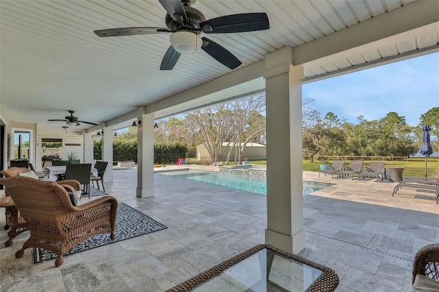 view of patio featuring a pool with hot tub and ceiling fan