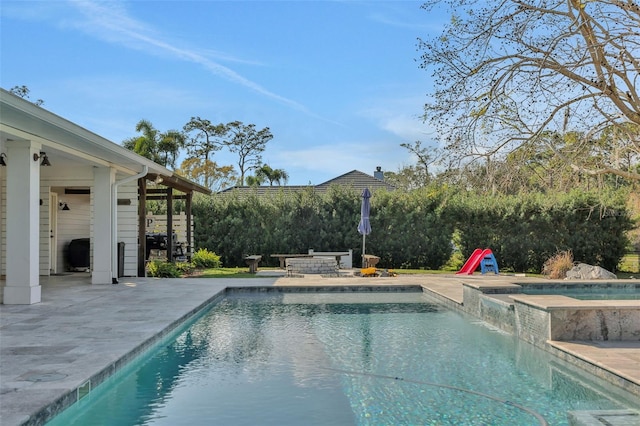 view of swimming pool with an in ground hot tub and a patio