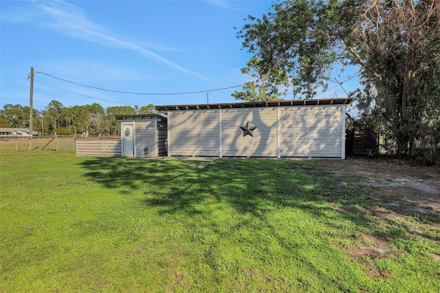 exterior space featuring an outdoor structure and a lawn