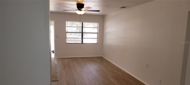 spare room with hardwood / wood-style flooring, plenty of natural light, and ceiling fan