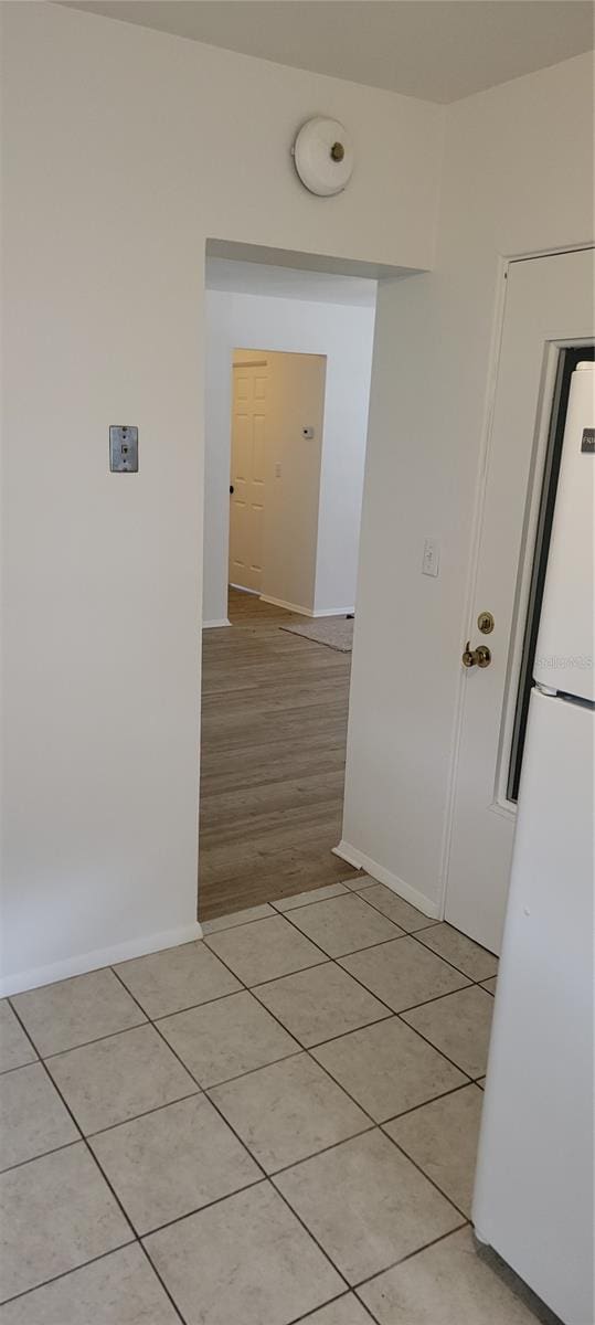 corridor with light tile patterned floors