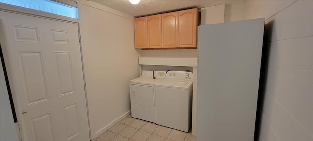 washroom featuring light tile patterned floors, independent washer and dryer, and a textured ceiling