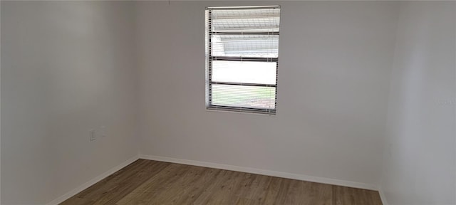 unfurnished room with hardwood / wood-style floors