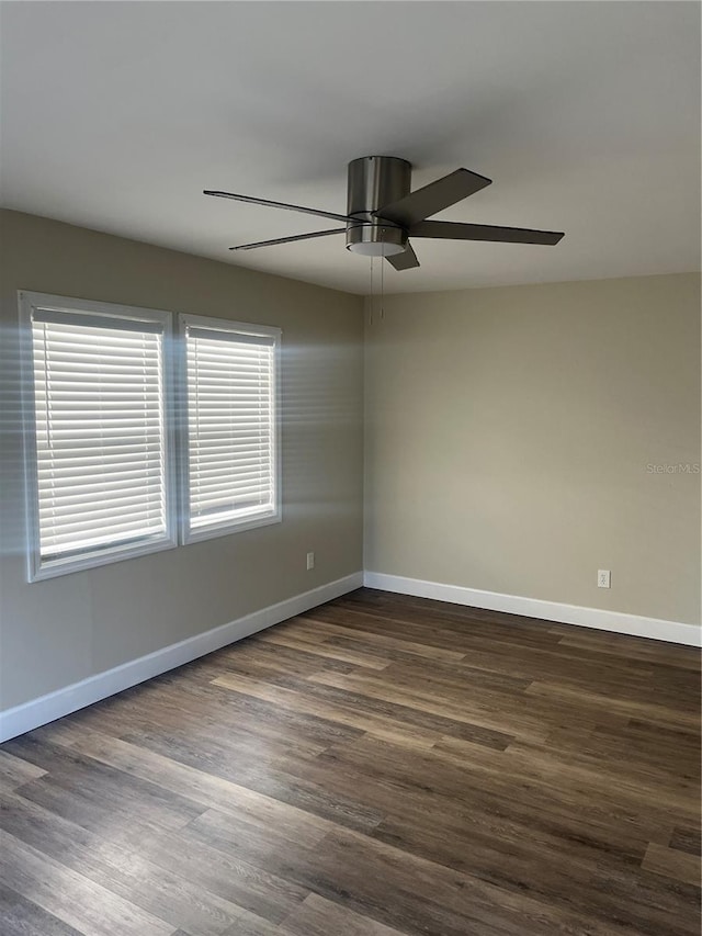 unfurnished room featuring dark wood-type flooring and ceiling fan