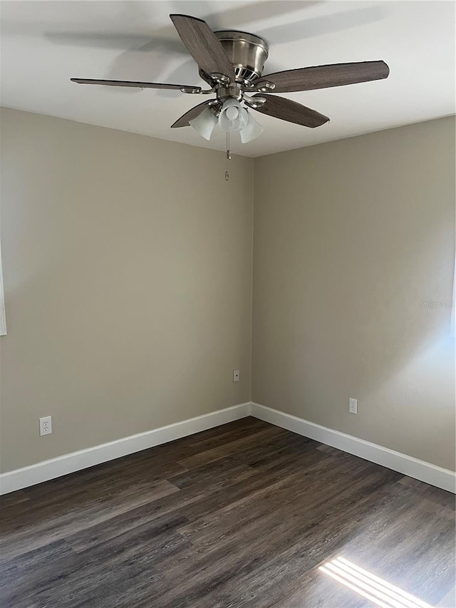 unfurnished room with ceiling fan and dark hardwood / wood-style flooring