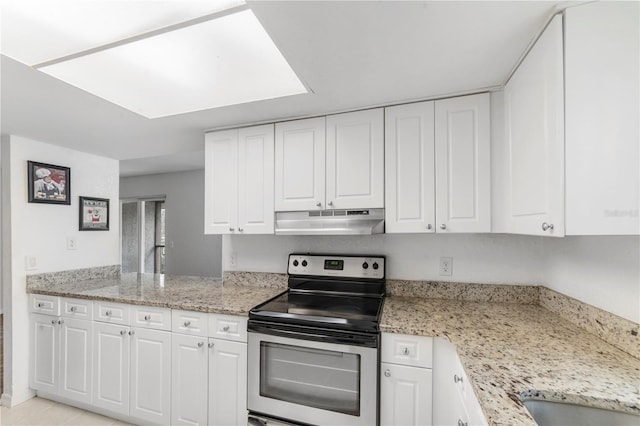 kitchen featuring white cabinetry, stainless steel range with electric stovetop, and light stone counters