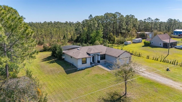 drone / aerial view featuring a view of trees