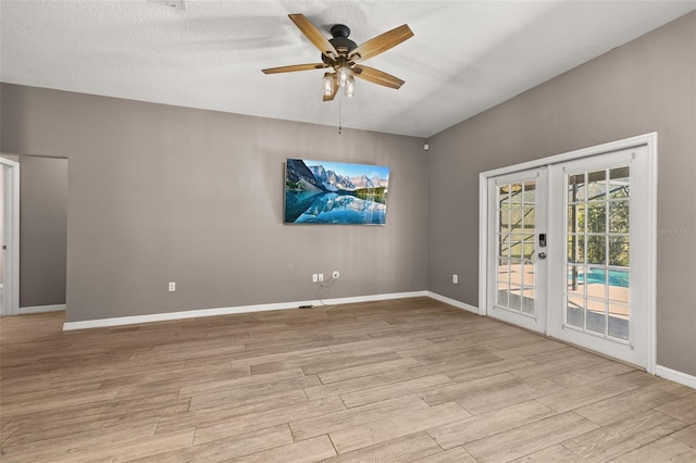 empty room featuring light wood-type flooring, french doors, ceiling fan, and baseboards