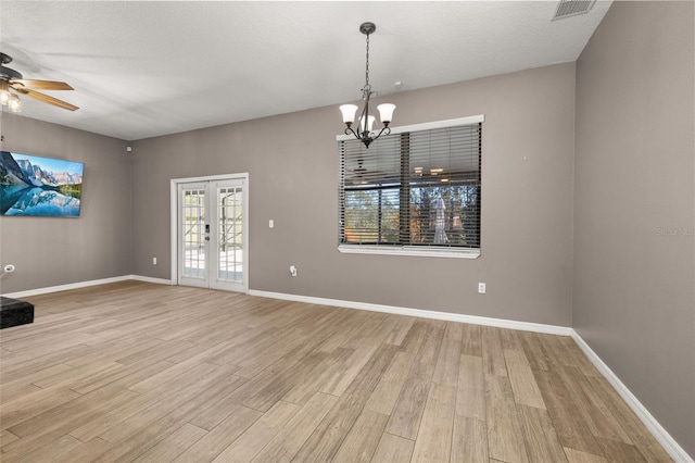 spare room featuring light wood-style floors, french doors, visible vents, and baseboards