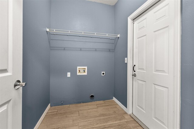 laundry room with hookup for an electric dryer, laundry area, washer hookup, wood finished floors, and baseboards