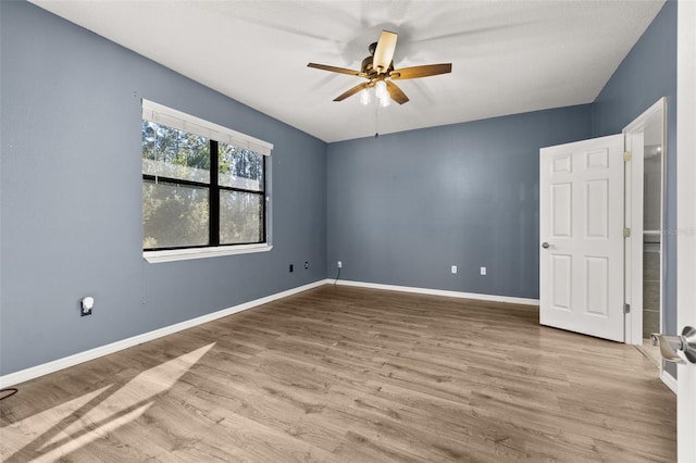 unfurnished room featuring a ceiling fan, baseboards, and wood finished floors