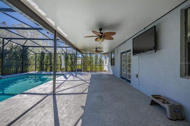 exterior space with glass enclosure, a ceiling fan, and a patio