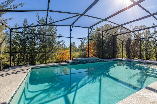 outdoor pool with a lanai and a jacuzzi