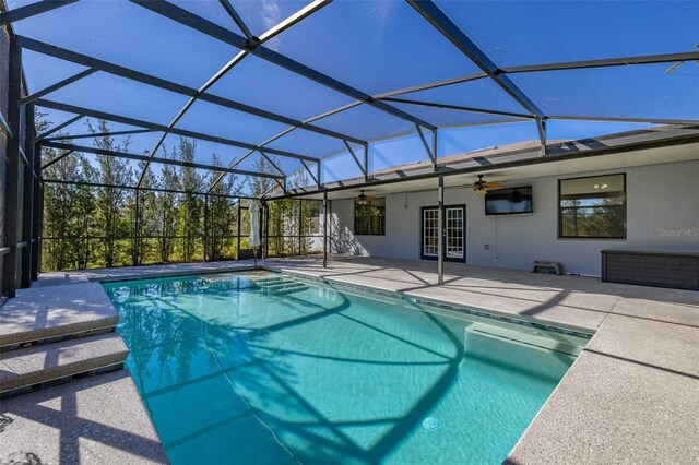 outdoor pool featuring a lanai, a patio, and french doors