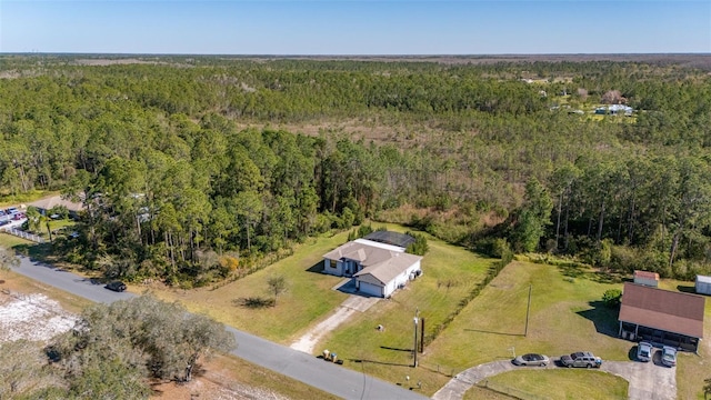 birds eye view of property with a forest view