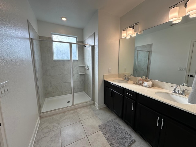 bathroom with tile patterned flooring, vanity, and walk in shower