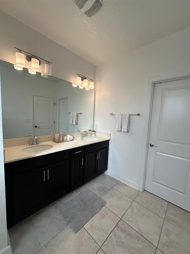 bathroom featuring tile patterned flooring and vanity