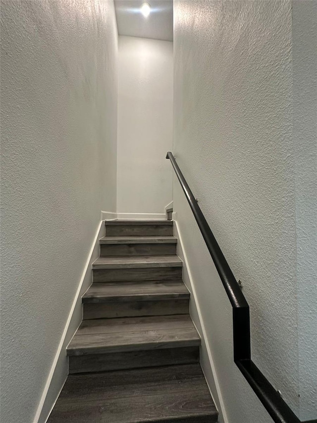 staircase with hardwood / wood-style flooring