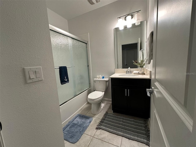 full bathroom featuring tile patterned floors, toilet, combined bath / shower with glass door, and vanity