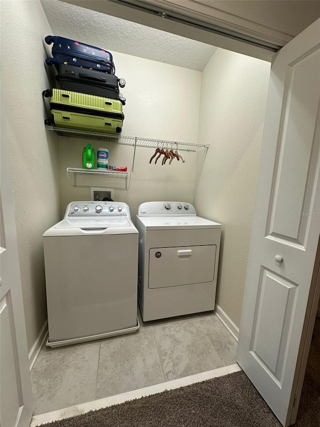 clothes washing area featuring independent washer and dryer