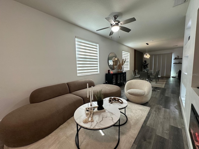 living room with ceiling fan and dark hardwood / wood-style floors