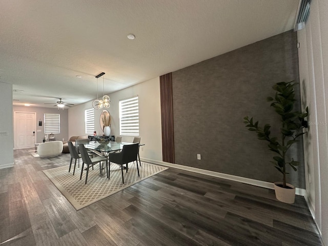 dining room featuring ceiling fan, dark hardwood / wood-style floors, and a textured ceiling