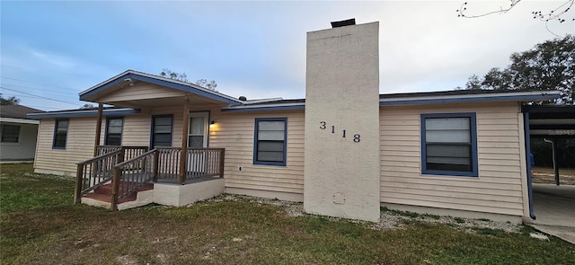 back of property featuring a lawn