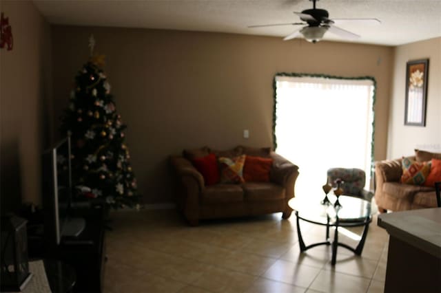 tiled living room with ceiling fan