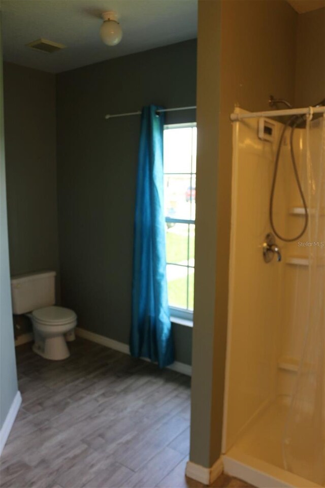 350 Chelmsford Ct, Kissimmee, FL 34758 - bathroom featuring a walk in shower and wood finished floors