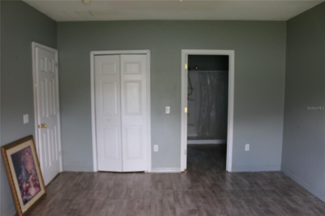 350 Chelmsford Ct, Kissimmee, FL 34758 - unfurnished bedroom with dark wood-style flooring and a closet