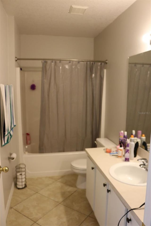 350 Chelmsford Ct, Kissimmee, FL 34758 - full bath featuring vanity, shower / bath combination with curtain, tile patterned floors, and a textured ceiling
